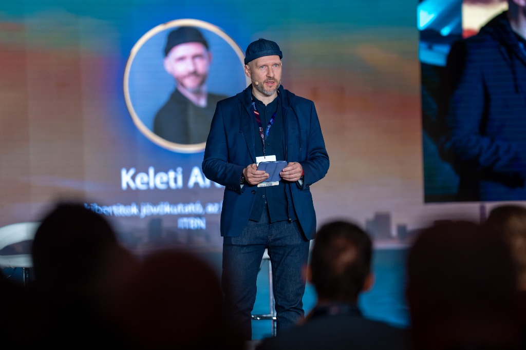 Arthur Keleti delivering keynote speech on stage at ITBN